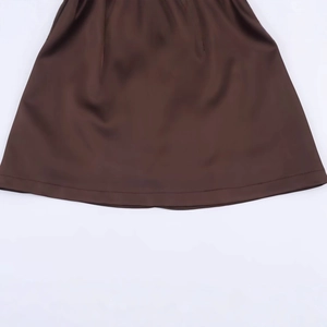 Brown satin halter neck dress featuring smooth fabric texture and refined stitching