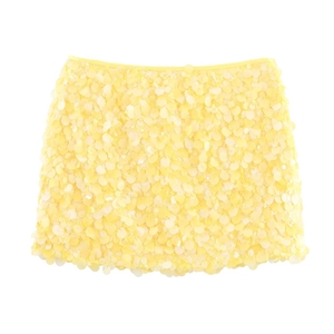 Detailed view of yellow sequin mini skirt with dense reflective circular paillettes