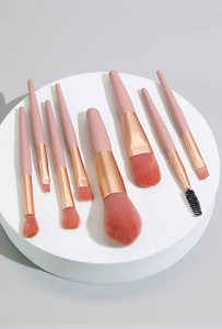 8-piece mini makeup brush set with pink handles and rose gold ferrules for precise application.
