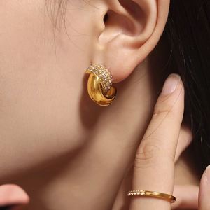 Elegant 18k gold plated crescent earrings with sparkling crystals worn by a model