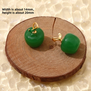 Detail of green apple charms with gold leaves on wood, size 14mm by 20mm