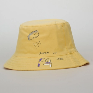 Detail of light yellow cotton bucket hat with cloud graffiti and Power of Love slogan