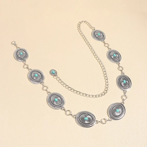 Detail of vintage bohemian silver metal waist chain with turquoise sunflower pattern