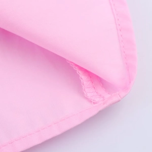 Close-up of high-quality pink poplin dress stitching and hemline craftsmanship details