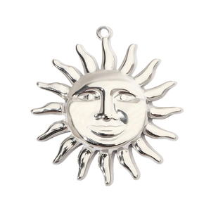 Detailed view of silver sun face pendant with radiant sunburst lines in stainless steel