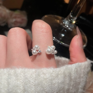 Macro detail of elegant French vintage ring with clusters of pearls and zircon accents