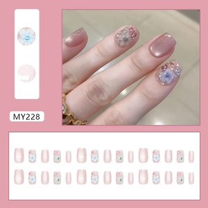 Press-on nail set featuring soft pink camellia flowers and glitter cat-eye effects