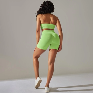 Close-up of neon green ribbed knit fabric on high-waist seamless yoga shorts set