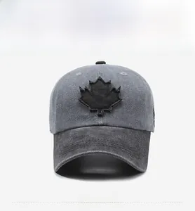 Front view of vintage grey washed cotton baseball cap with black maple leaf patch