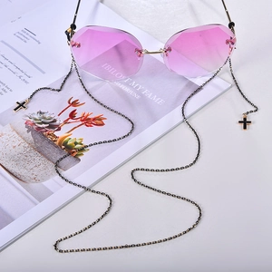 Frameless faceted rose red sunglasses with a decorative black cross metal eyewear chain