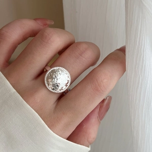 Minimalist silver textured round disc ring with adjustable opening for a modern look