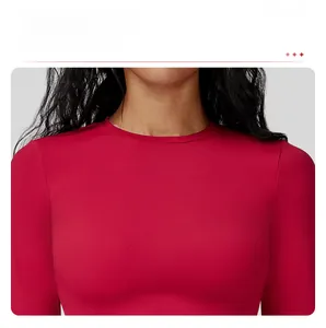 Close-up of classic round neckline on a red slim fit long sleeve sports yoga t-shirt