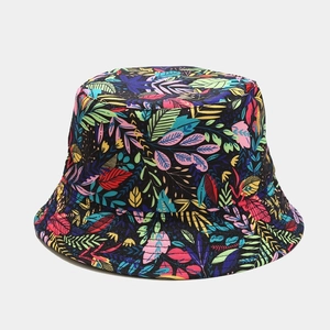 Detail of vibrant tropical leaf pattern on reversible black sun bucket hat fabric