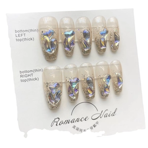 Handmade press-on nails set featuring Aurora rhinestones and pink glitter gradient