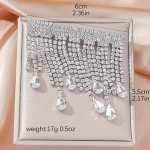 Elegant silver rhinestone tassel hair clip in a gift box with silk fabric background
