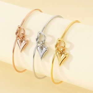 Polished stainless steel knot bracelets with heart pendants in gold, silver, and rose gold