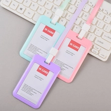 Three colorful ID card holders with fabric lanyards in pastel green, pink, and purple tones