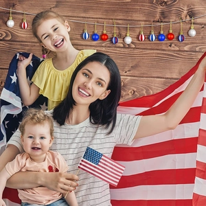 Detailed view of red, white, and blue patriotic American flag ornaments with hanging strings