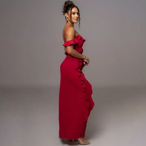 Side view of red backless slit maxi dress featuring 3D floral accent and ruffle details