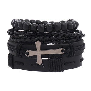 Detailed view of multilayer leather bracelet set with wooden beads and engraved cross
