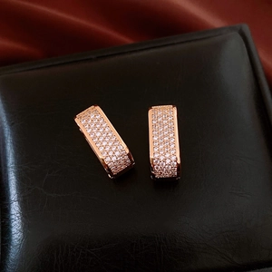 Gros plan de boucles d'oreilles en U plaquées or rose 18 carats avec micro-pavé de zircons