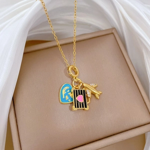 Gold titanium steel necklace with blue earth, suitcase, and plane charms on silk