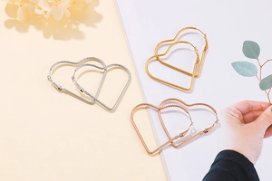 Three-color minimalist heart hoop earrings in gold, silver, and rose gold finishes