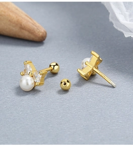 Detailed macro shot of S925 sterling silver bow earrings with pearls and crystals