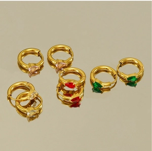 Detail view of gold hoop earrings with colorful teardrop-shaped zircon gemstones