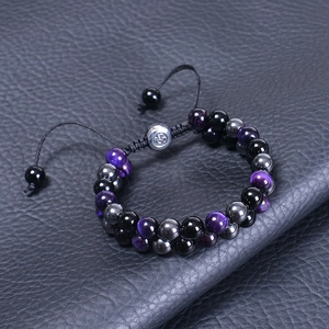 Close-up of double-layer tiger eye and obsidian bracelet with adjustable metal Om clasp