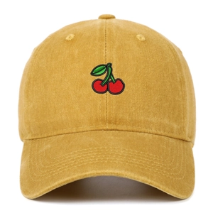 Close-up of fine cherry embroidery on mustard yellow washed cotton baseball cap texture