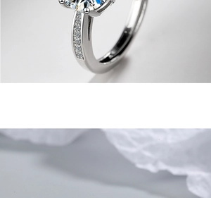 Macro shot of silver ring with large round solitaire stone and side diamond accents