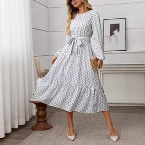 Detail of elegant floral print dress featuring lantern sleeves and ruffled tiered hemline