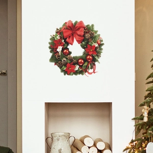 Sticker mural couronne de Noël adhésif avec nœud rouge et pommes de pin sur cheminée blanche
