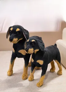 Detailed view of two realistic Doberman pinscher plush toys in classic black and tan fur