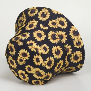 Detailed side view of a black canvas bucket hat featuring vibrant yellow sunflower prints