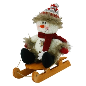 Plush Christmas snowman doll sitting on a wooden sled with red knitted hat decoration