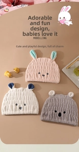 Detailed view of plush coral fleece hair drying hats with cute animal ear embroidery