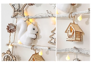 Close-up of wooden house and star ornaments with LED lights on Christmas tree branches