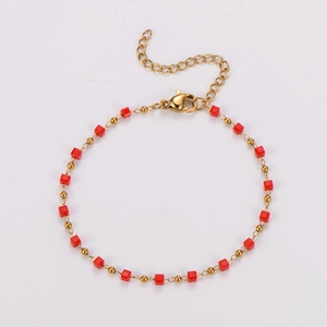 Detail view of red square beads on a gold-plated beaded chain with a lobster clasp
