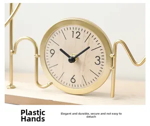 Detail of minimalist metal frame clock with wooden dial and elegant golden geometry