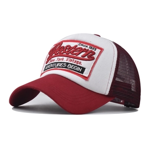 Detail showing 3D Western embroidery on retro trucker hat with red mesh and white front