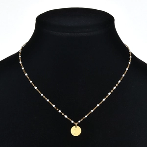 Golden stainless steel necklace with white beads and moon star coin pendant on black stand