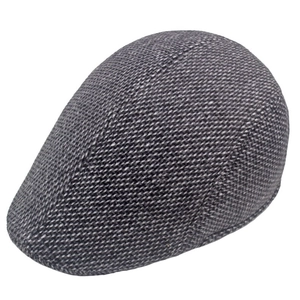 Close-up of grey herringbone wool fabric texture on a winter flat cap for men