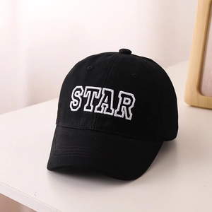 Close-up of black cotton baseball cap featuring white STAR embroidery and curved brim