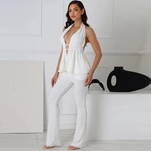 Chic white two-piece set featuring a halter deep V-neck top and textured flare pants