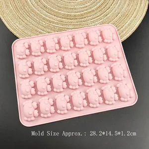 Pink 28-cavity crab silicone mold for chocolate, jelly and baking on a grey surface