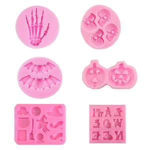 Pink silicone baking molds featuring Halloween bats pumpkins and skulls for cake fondant