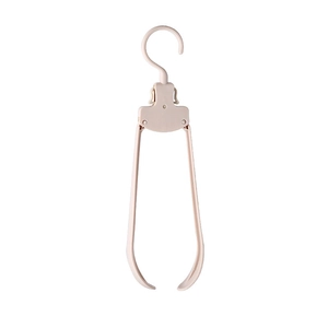 Portable pink folding clothes hanger with wide shoulders for travel and home storage use