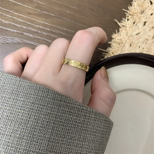 Textured gold dragon scale ring in stainless steel worn on finger for elegant look